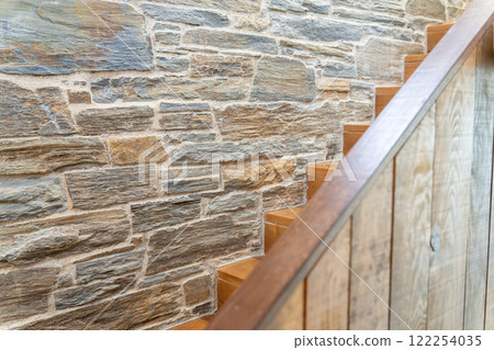 Rustic Stone Wall with Wooden Staircase 122254035