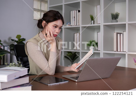 Asian female student studying online Video calls through Zoom about business administration and accounting subjects attentively Asian female student studying online Video calls through Zoom about business administration and accounting subjects attentively 122254121