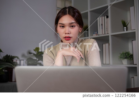 Asian female student studying online Video calls through Zoom about business administration and accounting subjects attentively Asian female student studying online Video calls through Zoom about business administration and accounting subjects attentively 122254166