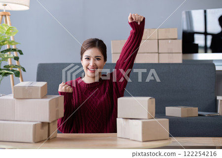Small business owner celebrates success with successful online shopping business 122254216
