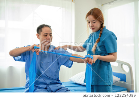 A sick caregiver or young nurse is helping a patient who is rehabilitating with physical therapy at the hospital. A sick caregiver or young nurse is helping a patient who is rehabilitating with physical therapy at the hospital. 122254389