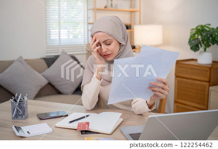 A business woman is tired and sad after having financial problems and credit card debt. A business woman is tired and sad after having financial problems and credit card debt. 122254462