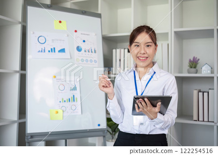 Businesswoman with presentation board at a meeting about work plans Finance and business results graphs Businesswoman with presentation board at a meeting about work plans Finance and business results graphs 122254516