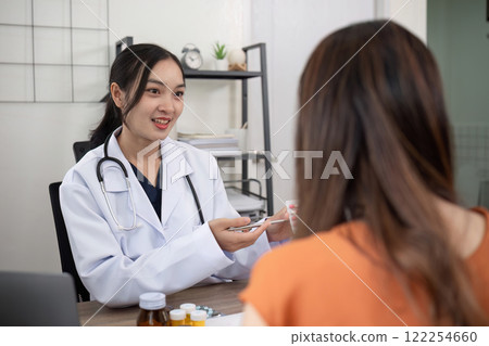 Female doctor and elderly female patient consulting about health problems in clinic 122254660