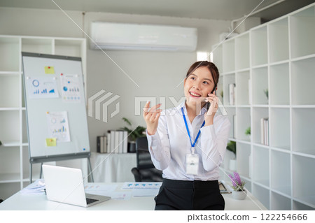 Asian businesswoman talking on the phone in an online business meeting in a modern office 122254666