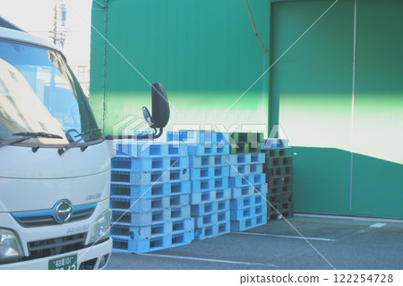 Truck and stacked pallets Truck and stacked pallets 122254728