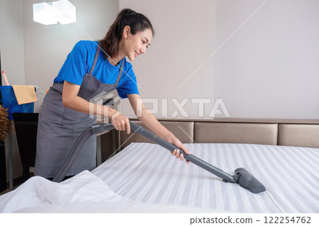 Hotel cleaning staff uses a mop to clean the living room. 122254762