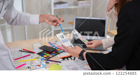 Application development team Meet together to brainstorm ideas for planning ux ui of the application for smartphones Application development team Meet together to brainstorm ideas for planning ux ui of the application for smartphones 122254885