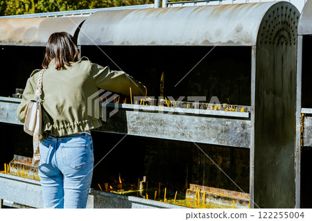 People pray and light candles at the temple People pray and light candles at the temple 122255004