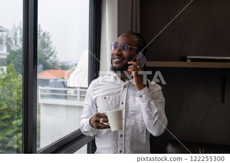 Young African American businessman dressed casually Work from your laptop while you're on vacation by working from home. 122255300
