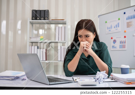 Young businesswoman is having problems with her work at work. Feeling stressed and unhappy because the results did not meet the goals Young businesswoman is having problems with her work at work. Feeling stressed and unhappy because the results did not meet the goals 122255315