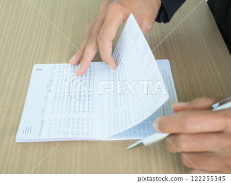 Hand holding Bank Account Book Statement Balance Number Cash, Hand Holding Data Investment Debt Math in Office, Bill Receipt and Payment Business Credit Card Account, Check Paper Financial. 122255345