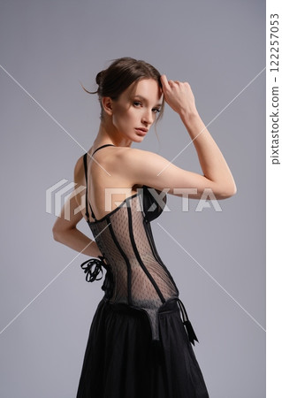 Elegant woman in stylish black corset lingerie posing indoors Elegant woman in stylish black corset lingerie posing indoors 122257053