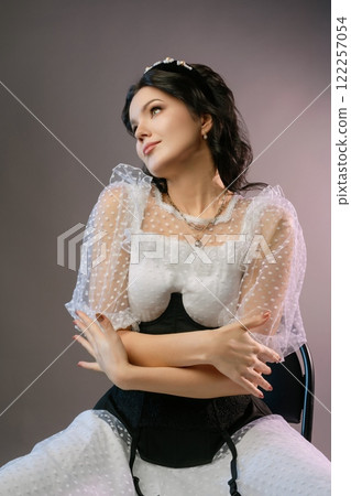 Elegant woman in corset and lingerie showcasing unique fashion style 122257054