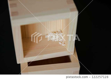 A small amount of rice remaining in a toppled wooden box A small amount of rice remaining in a toppled wooden box 122257128