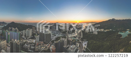 Urban Skyline at Sunset Overlooking Harbor and Mountains, HK Jan 12 2025 Urban Skyline at Sunset Overlooking Harbor and Mountains, HK Jan 12 2025 122257219