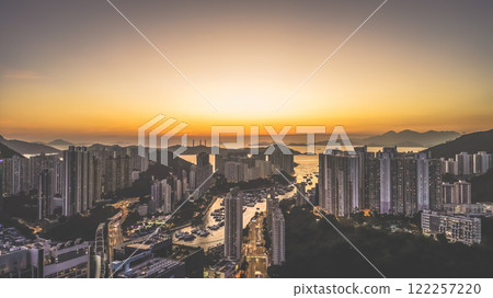 Urban Skyline at Sunset Overlooking Harbor and Mountains, HK Jan 12 2025 Urban Skyline at Sunset Overlooking Harbor and Mountains, HK Jan 12 2025 122257220