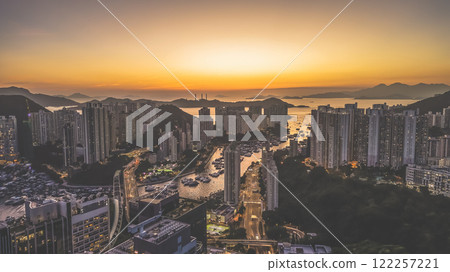 Urban Skyline at Sunset Overlooking Harbor and Mountains, HK Jan 12 2025 Urban Skyline at Sunset Overlooking Harbor and Mountains, HK Jan 12 2025 122257221