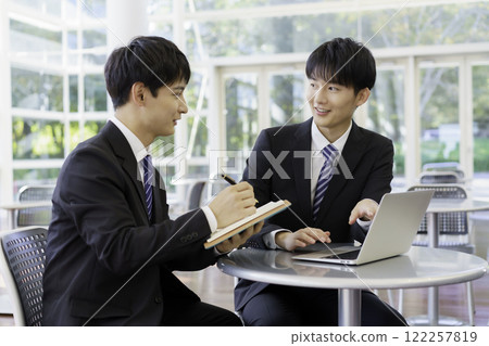 Two young businessmen having a meeting in an office building Presentation Sales Meeting Two young businessmen having a meeting in an office building Presentation Sales Meeting 122257819