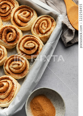 Delicious cinnamon rolls prepared for baking in a rectangular pan Delicious cinnamon rolls prepared for baking in a rectangular pan 122258455