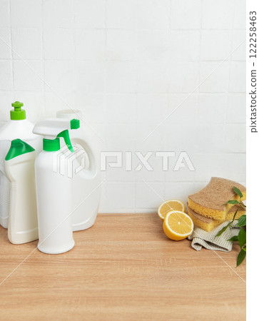 Cleaning products, sponges and lemons resting on countertop Cleaning products, sponges and lemons resting on countertop 122258463