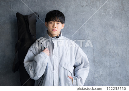 Image of holding equipment for winter sports such as snowboarding and skiing 122258530