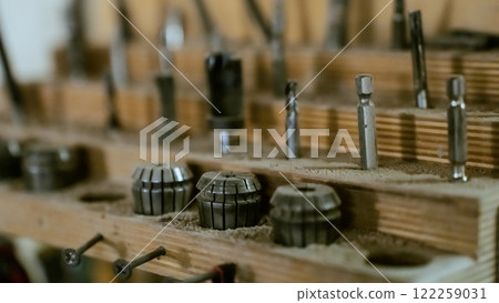 Various tools: file, screwdriver, hammer, pliers, garden tools are displayed on wooden shelf inside rustic garage or manufactory, workshop studio in a rustic garden house. Hobby, leasure activity Various tools: file, screwdriver, hammer, pliers, garden tools are displayed on wooden shelf inside rustic garage or manufactory, workshop studio in a rustic garden house. Hobby, leasure activity 122259031