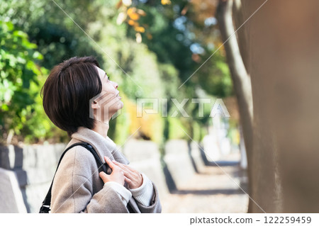 A woman walking outdoors 122259459