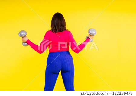 Full length photo of a young smiling fat overweight woman wearing sportswear Full length photo of a young smiling fat overweight woman wearing sportswear 122259475