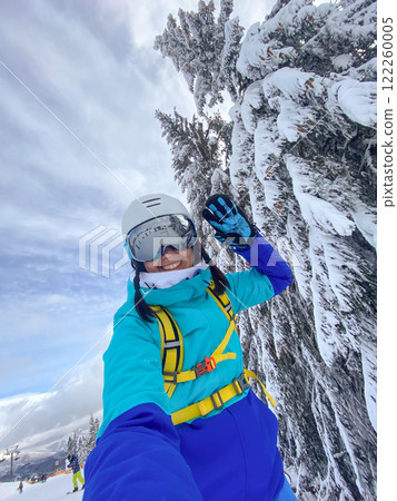Smiling Woman with Skis on Snowy Slope Smiling Woman with Skis on Snowy Slope 122260005