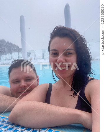 Couple Relaxing in a Geothermal Pool Couple Relaxing in a Geothermal Pool 122260030