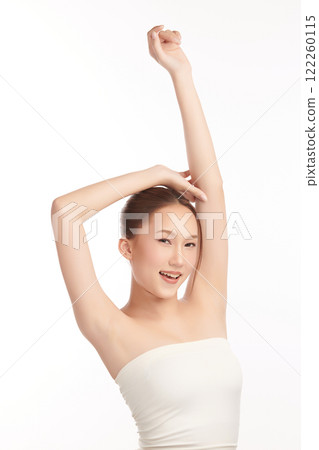 Beautiful Young Asian woman lifting hands up to show off clean and hygienic armpits or underarms on white background, Smooth armpit cleanliness and protection concept 122260115