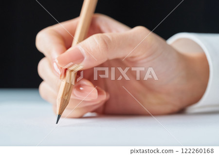 Hand holding a pencil and blank paper Hand holding a pencil and blank paper 122260168