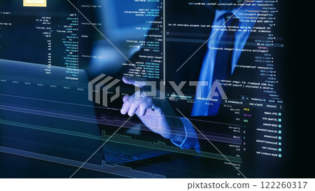 Close-up of hands on laptop keyboard, surrounded by floating, translucent layers of fictional code, representing virtual programming and system diagnostics. Close-up of hands on laptop keyboard, surrounded by floating, translucent layers of fictional code, representing virtual programming and system diagnostics. 122260317