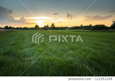 Mowed grass in the meadow and sunset Mowed grass in the meadow and sunset 122261209