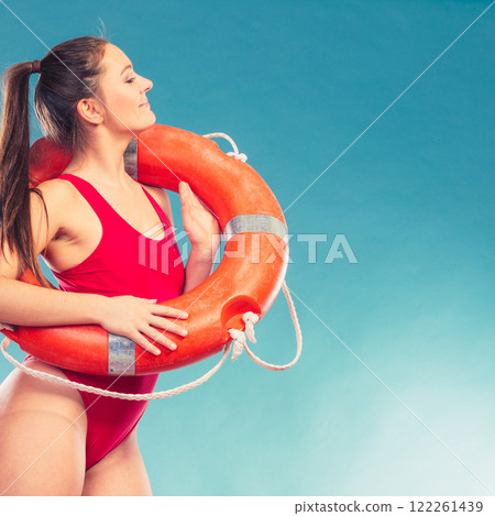 Lifeguard woman on duty with ring buoy lifebuoy. Lifeguard woman on duty with ring buoy lifebuoy. 122261439