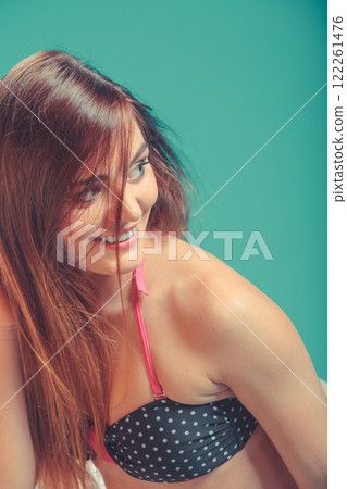 Portrait of seductive woman at poolside edge. 122261476