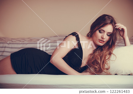 Seductive young woman in lingerie in bed. Seductive young woman in lingerie in bed. 122261483