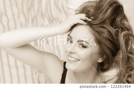 Portrait of happy young woman in lingerie in bed. Portrait of happy young woman in lingerie in bed. 122261484