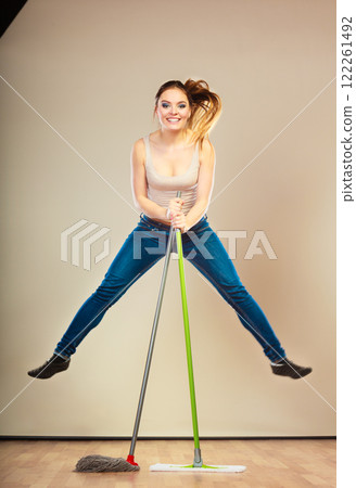 Funny cleaning woman mopping floor jumping 122261492