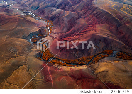 Aerial view of colorful mountain valley with winding river during autumn season 122261719