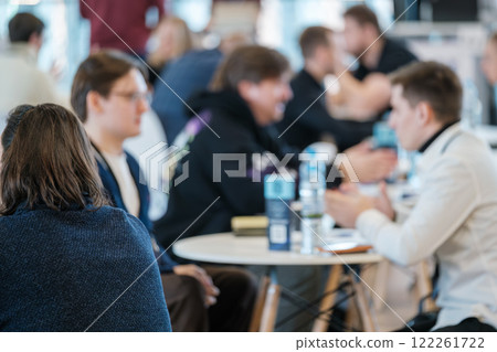 Business professionals engaging in a lively and productive discussion at a conference 122261722