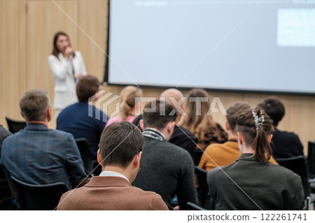 Audience attentively listening to a speaker during a business seminar Audience attentively listening to a speaker during a business seminar 122261741
