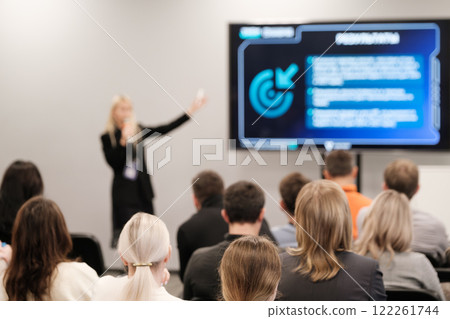 Speaker presenting to audience in a modern conference room setting 122261744