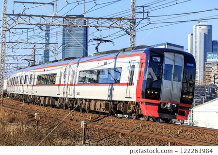 Meitetsu 2200 series express train running with Nagoya's skyscrapers in the background Meitetsu 2200 series express train running with Nagoya's skyscrapers in the background 122261984