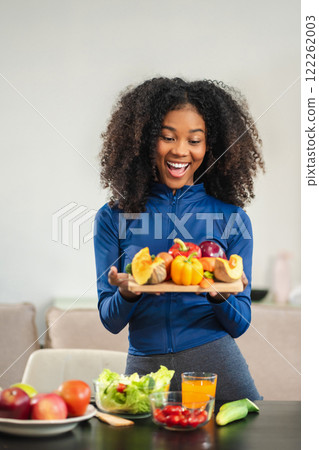 Lifestyle woman enjoys healthy fruit breakfast after yoga training. fitness, nutrition, home lifestyle. 122262003