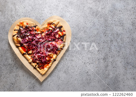 Food for Valentine's Day. Heart shaped sweet pizza with pineapple on gray background. View from above. Love concept. Romantic dinner. Copy space. 122262460