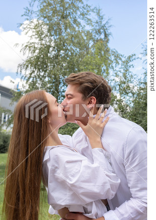 Loving couple of young girl and man are walking and having fun in park on warm summer day. High quality photo Loving couple of young girl and man are walking and having fun in park on warm summer day. High quality photo 122263514