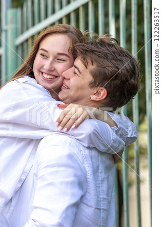 Close-up portrait of couple in love. Young woman and men walking and having fun in park on warm summer day. Vertical photo. High quality photo 122263517