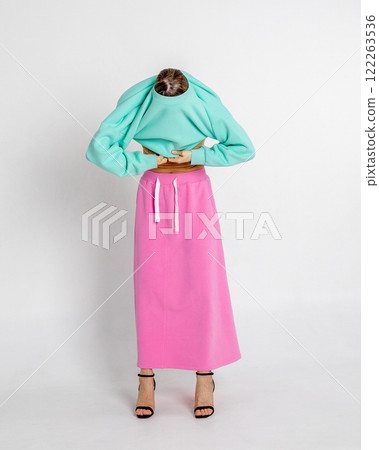 Beautiful girl of model appearance. Portrait of beautiful woman in mint color sweatshirt and pink skirt. Vertical photo. High quality photo Beautiful girl of model appearance. Portrait of beautiful woman in mint color sweatshirt and pink skirt. Vertical photo. High quality photo 122263536